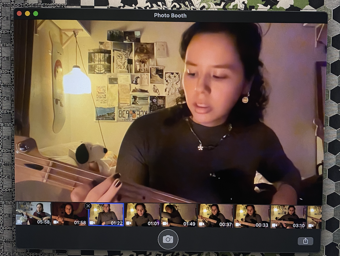a picture of Claudia practicing bass in their room